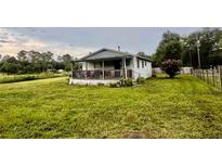 Cute ranch home with a spacious front yard and covered porch at 708 Lake Shore Dr, Pierson, FL 32180