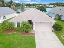 Property front elevation showcasing a two-car garage and landscaped yard at 875 Delfino Pl, Lake Mary, FL 32746