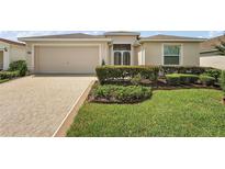 One-story home with beige exterior and landscaping at 27227 Roanoke Dr, Leesburg, FL 34748