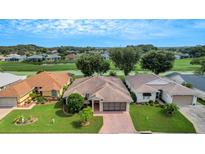 Aerial view of single Gathering home, showing landscaping and neighborhood at 317 Ranchwood Dr, Leesburg, FL 34748