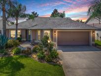 Well-maintained house with landscaped lawn, driveway, and two-car garage at 616 Cokesbury Dr, The Villages, FL 32162