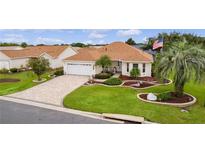 Single-story home with a landscaped yard and paver driveway at 3401 Fairfield St, The Villages, FL 32162