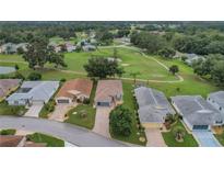 Aerial view of homes and golf course community at 32915 Crooked Oaks Ln, Leesburg, FL 34748