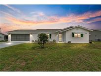 Single-story house with white siding and carport at 9823 Se 178Th Ln, Summerfield, FL 34491