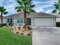 Charming single-story home with landscaped yard and driveway at 3365 Boardroom Trl, The Villages, FL 32163