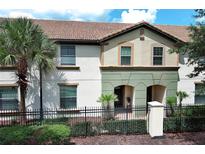 Two-story townhome with a Spanish-style roof and a well-maintained front yard at 2019 Majorca Dr, Kissimmee, FL 34747