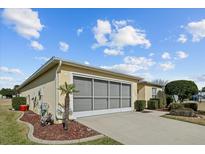 Attached garage with a screened enclosure, and landscaping at 15300 Sw 14Th Avenue Rd, Ocala, FL 34473