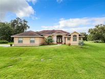 One-story house with attached garage and manicured lawn at 275 Cr 552, Bushnell, FL 33513