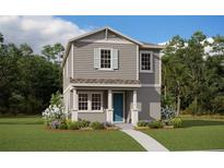 Two-story craftsman style home with a teal door at 17036 Clear Mind Aly, Winter Garden, FL 34787