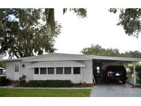 Single-wide mobile home with carport at 101 Poinsettia Cv, Leesburg, FL 34748