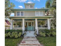 Two-story home with a large front porch and landscaping at 101 S Dixie Ave, Fruitland Park, FL 34731
