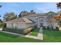 Two-story house with a gray exterior, brown roof, and landscaped yard at 24126 Plymouth Hollow Cir, Sorrento, FL 32776