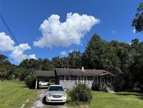 One-story house with purple shutters and a carport at 11311 Se 132Nd Pl, Ocklawaha, FL 32179