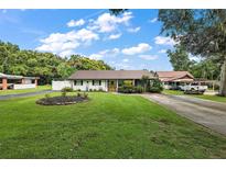 Charming single story home with a well manicured lawn and long driveway at 205 Josephine Ave, Fruitland Park, FL 34731