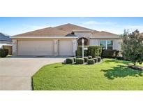 One-story home with a two-car garage and manicured lawn at 3357 Wise Way, The Villages, FL 32163