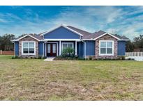 New construction home features stone accents and a welcoming front porch at 38530 Wooded Meadow Drive, Umatilla, FL 32784