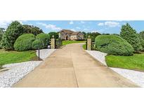 Long driveway leading to a two-story house at 10860 Ne 27Th St, Oxford, FL 34484