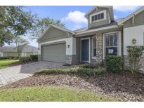 Craftsman style home with brick and gray siding at 34416 Tuscany Ave, Sorrento, FL 32776