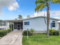 Single-story home with light blue siding and covered carport at 622 Dreama Dr, Davenport, FL 33897