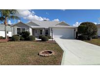 Charming single-story home with a landscaped front yard and attached two-car garage at 17755 Se 85Th Ellerbe Ave, The Villages, FL 32162