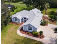 House nestled in a lush neighborhood with a golf course nearby at 39112 Treeline Dr, Lady Lake, FL 32159