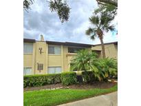 Exterior view of a condo building with landscaping at 6116 Curry Ford Rd # 229, Orlando, FL 32822
