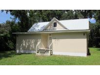 Small house with a metal roof and simple exterior design at 214 W Dade Ave, Bushnell, FL 33513
