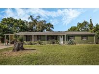 Green Ranch style home with mature landscaping at 402 Sunset Dr, Sanford, FL 32773