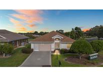 Single-story house with a brown roof and a two-car garage at 17549 Se 115Th Terrace Rd, Summerfield, FL 34491