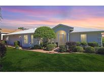 Single story home with landscaped yard and screened porch at 4809 Saint Andrews Arc, Leesburg, FL 34748