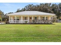Charming one-story house with metal roof and porch at 218 Ann St, Lady Lake, FL 32159
