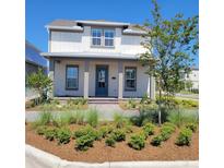 Two-story house with light-colored siding, a gray roof, and a teal door at 10425 Medawar St, Orlando, FL 32827