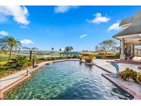 Resort-style pool with lake views and spacious patio at 17601 Sawgrass Run, Tavares, FL 32778