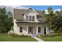 Two story farmhouse style home with landscaping at 9934 Fiddley Aly, Orlando, FL 32827