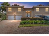Townhouse exterior with two-car garage and landscaped entryway at 5279 Bowline Ct, Oxford, FL 34484