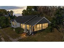 Charming one-story home with sunroom and grey roof at 462 W Osceola St, Clermont, FL 34711