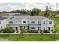 Attractive townhouses with landscaping and a walking path at 2226 Gopher Tortoise Ter, Oakland, FL 34787