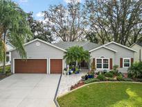 Attractive single-Gathering home with three-car garage and lush landscaping at 3721 Plantation Blvd, Leesburg, FL 34748