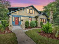 Charming craftsman home with a red door and landscaped yard at 351 W 10Th Ave, Mount Dora, FL 32757