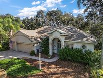 One-story house with a two-car garage at 3646 Westover Cir, Leesburg, FL 34748
