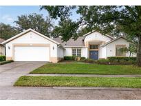 Two-story home with a two car garage and landscaped lawn at 6029 Falconbridge Pl, Mount Dora, FL 32757