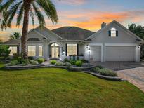 Two-story home with landscaping and a three-car garage at 1277 Bennett Pl, The Villages, FL 32162