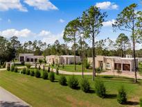 Luxury estate home with expansive grounds and private driveway at 39851 & 39855 Darlington Ave, Lady Lake, FL 32159