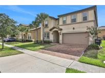 Two-story house with two-car garage and manicured lawn at 1603 Lima Ave, Kissimmee, FL 34747