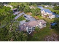 Aerial view of residential buildings near a canal at 22103 Sandalwood Dr # 103, Wildwood, FL 34785
