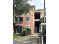 Two-story condo building with balconies and a staircase leading to upper units at 13584 Turtle Marsh Loop # 132, Orlando, FL 32837