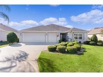 Attractive single-story home with a three-car garage and manicured landscaping at 3402 Fountainhead Ave, The Villages, FL 32163