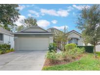 One-story house with a two-car garage and landscaped yard at 4130 Capland Ave, Clermont, FL 34711