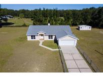 Aerial view of a single-story house with a detached shed and large yard at 7921 Jacksons River Rd, Leesburg, FL 34788