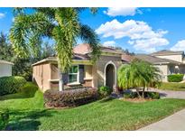 Inviting curb appeal featuring a well-maintained lawn and landscaping at 2915 Etowah Park Blvd, Tavares, FL 32778